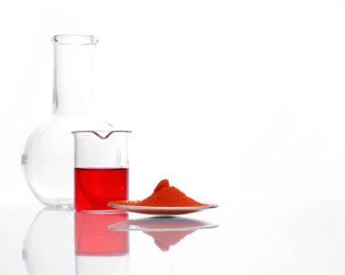 Potasyum Dichromate, beher içinde Potasyum Ferrisiyanür sıvısı ve Borosiliate Glass 'ın (Borosiliate Glass) yanında beyaz laboratuvar masasında. Yan Görünüm