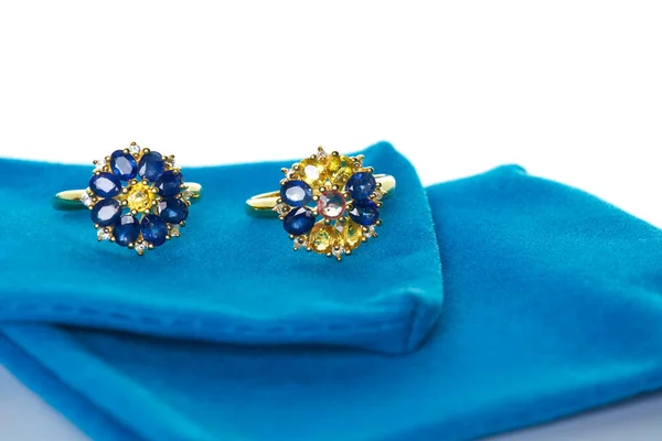 Blue and yellow sapphire Jewel or gems ring on velvet bag. Collection of natural gemstones accessories. Studio shot