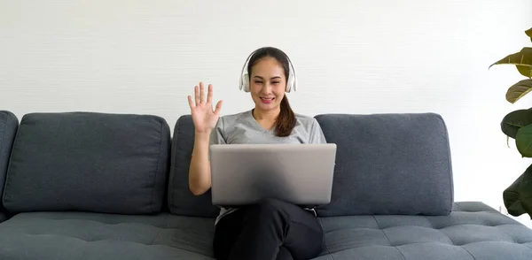 Asian Woman Gray Shirt Headphone Waving Hand Remote Communication Laptop — Stock Photo, Image