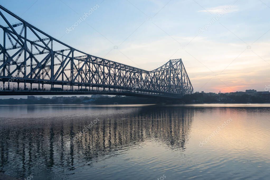 Early morning view of Howrah Bridge, The Bridge is a balanced cantilever bridge over the Hooghly River in Kolkata, Commissioned in 1943, Kolkata, West Bengal, India.