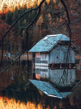 A reflection of a hut in the lake