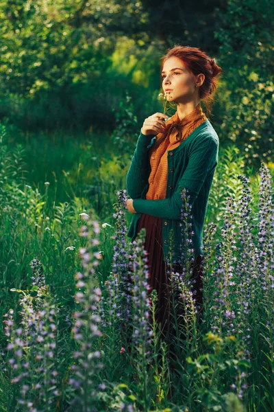 Portret pięknej dziewczyny z brązowymi włosami wśród kwiatów na polu. letnie wakacje z kwiatami. wiejskie — Zdjęcie stockowe