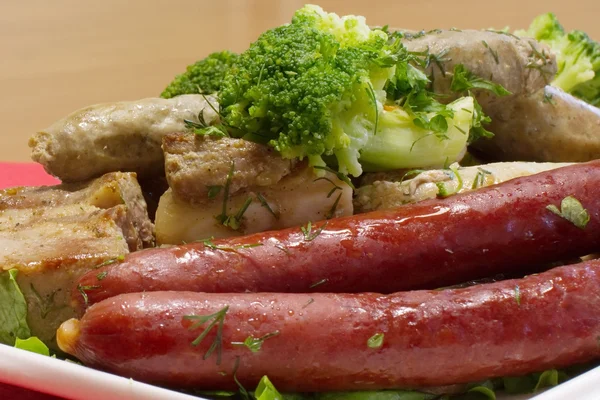 Plate with several kinds of sausages and slices of roasted meat — Stock Photo, Image