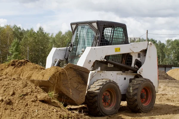 Le petit bulldozer gagne du terrain dans le seau — Photo