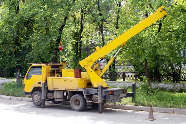 Yellow car with the lift is on the street — Stock Photo, Image