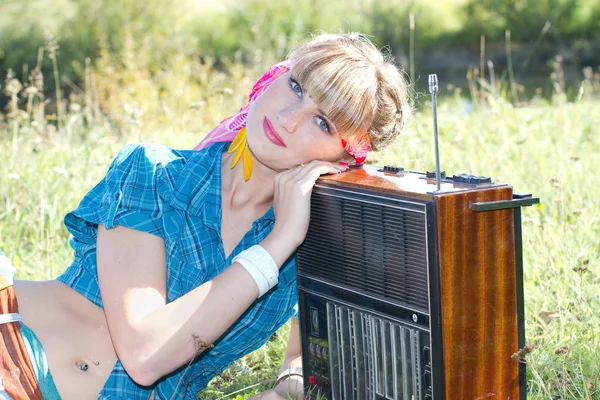 Young beautiful girl sitting outdoors with a tape recorder — Stock Photo, Image