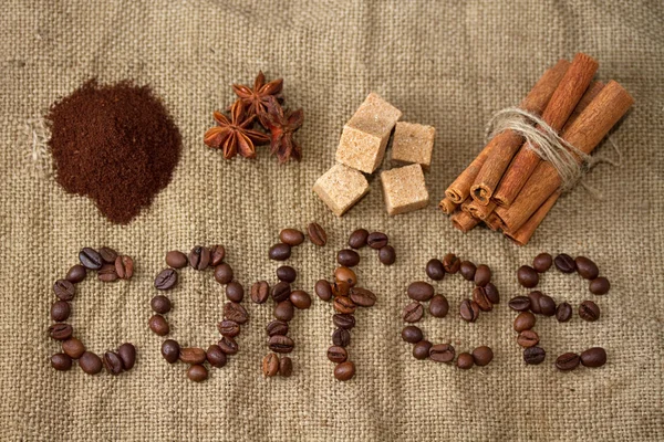 Word of coffee with coffee beans laid out on a canvas background — Stock Photo, Image