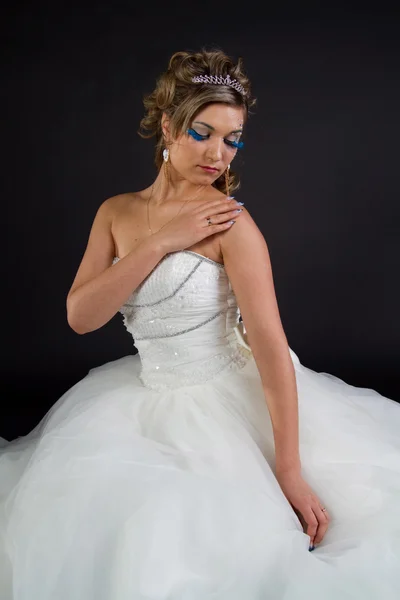 Young sexy girl in a wedding dress on a dark background — Stock Photo, Image