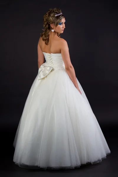 Young sexy girl in a wedding dress on a dark background — Stock Photo, Image