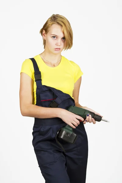 Young beautiful girl in blue overalls and yellow T-shirt — Stock Photo, Image