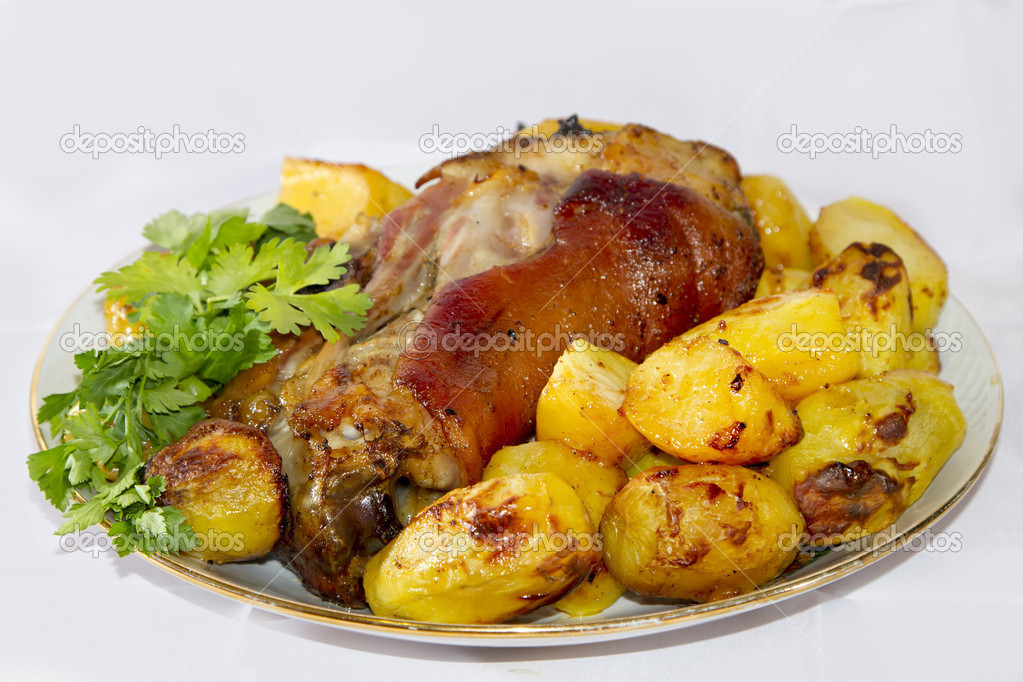 Baked pork shank with potatoes and parsley