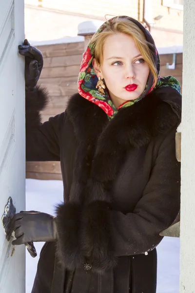 Pretty Slavic girl in a black coat — Stock Photo, Image