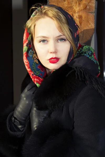 Pretty Slavic girl in a black coat and a colored scarf — Stock Photo, Image