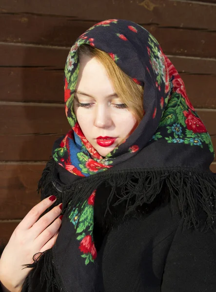 Pretty Slavic girl in a black coat and a colored scarf — Stock Photo, Image