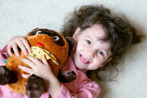 Entzückendes kleines Mädchen umarmt großen Teddybär — Stockfoto