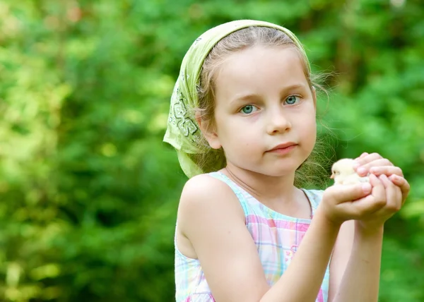 Little girl with chicken outdoors — Stock Photo, Image