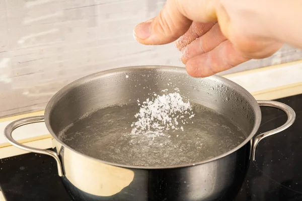 Лейте Соль Металлический Горшок Кипящей Водой Рукой — стоковое фото