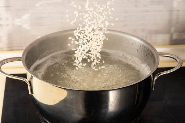 pour the rice into a metal pot of boiling water