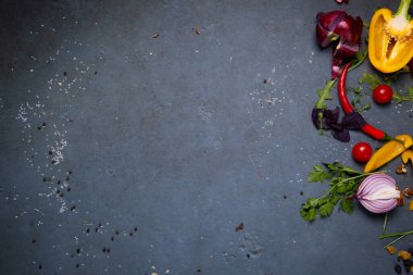 Sarı dolma biber, sarımsak, soğan, roka ve domates gri arka planda kabuk bağlar. Sağlıklı beslenme kavramı, lezzetli yemekler. Baharatlar. Metin uzayı