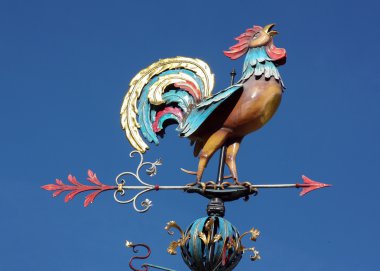 Weather vane in the form of a cock clipart