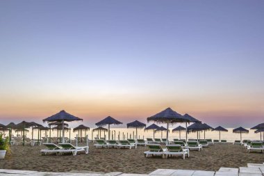 View of Beach in Torremolinos with umbrellas, Spain. Sunset