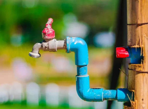 Old and dirty faucet with pvc pipes — Stock Photo, Image