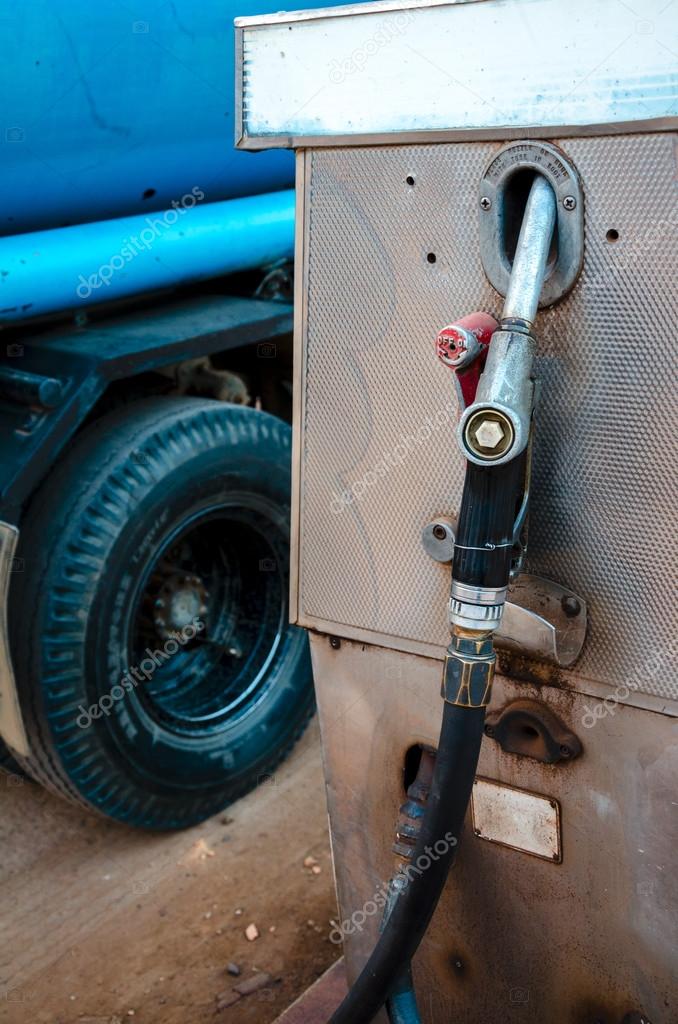 Old dirty gas station pump with fuel truck — Stock Photo © boydz1980