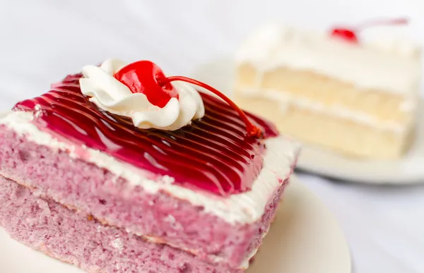 Cake with mousse whipping cream and cherry on top — Stock Photo, Image