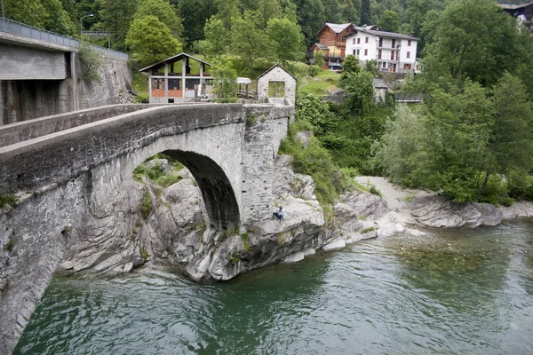 Bridge on the river with fisherman — Stock Photo, Image