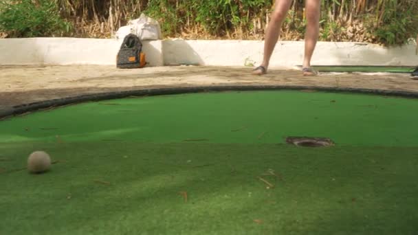 Nsan Minigolf Oynar Detaylar Sadece Ayaklarında Kahverengi Sandaletlerle Yeşil Yüzey — Stok video