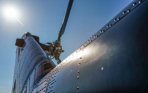 Looking up military helicopter rear rotor and blades, bright sun and sky background — Stock Photo, Image