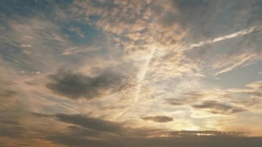 Morning blue orange sky, sun shining through clouds - timelapse video