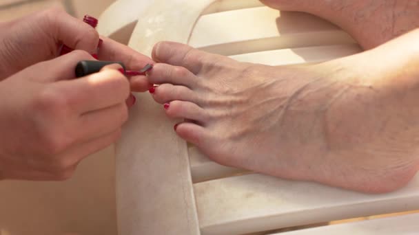 Young Woman Applying Red Nail Polish Older Woman Feet Relaxing — Wideo stockowe