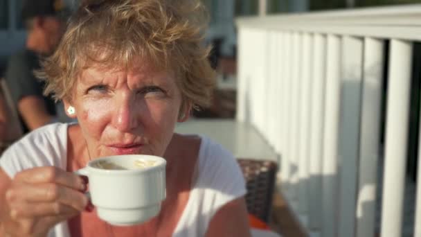Elderly Senior Woman Drinking Coffee White Cup Terrace Sun Shines — Vídeos de Stock