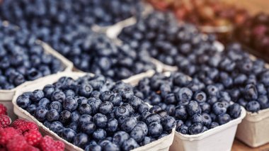 Yiyecek pazarında yaban mersini sergilenen küçük karton kutular, kapanış ayrıntıları