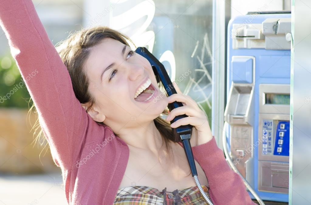 A happy woman talking at phone