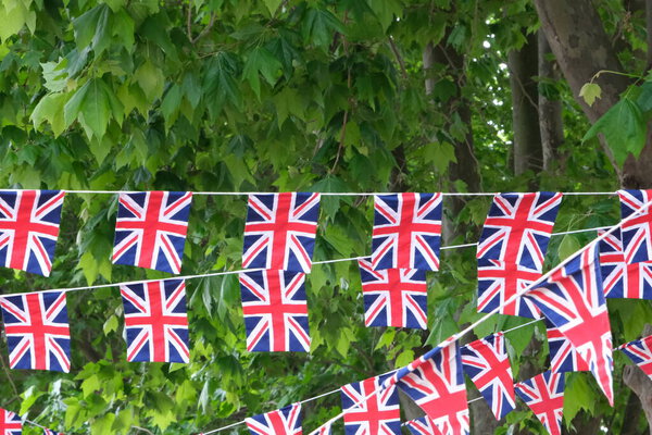 British flags hanging on the streets of London. Union jack flag triangular outside decoration