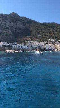 Summer landscapes from Levanzo, Sicily, Italy. Holidays in Sicily. Clear water, floating boats near the shore. 