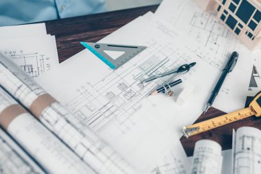 Tool Architect  angle protector, compass, pen and tape measure on bueprint. House planning design and construction concept.