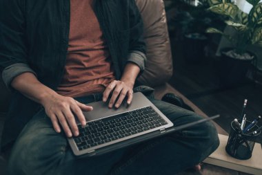 Men using laptop to working, play game, listen music or relaxing on sofa at home. Relax home concept.