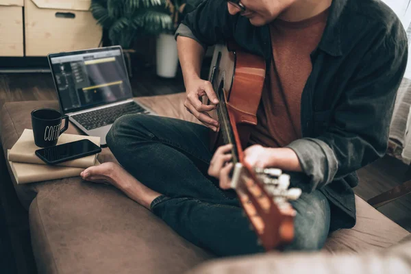 Young Man Relax Playing Guitar While Sitting Sofa Bed Living — 图库照片