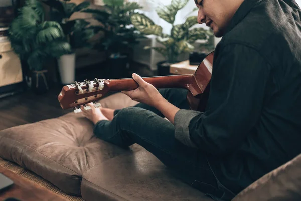 Young Man Relax Playing Guitar While Sitting Sofa Bed Living — Stockfoto