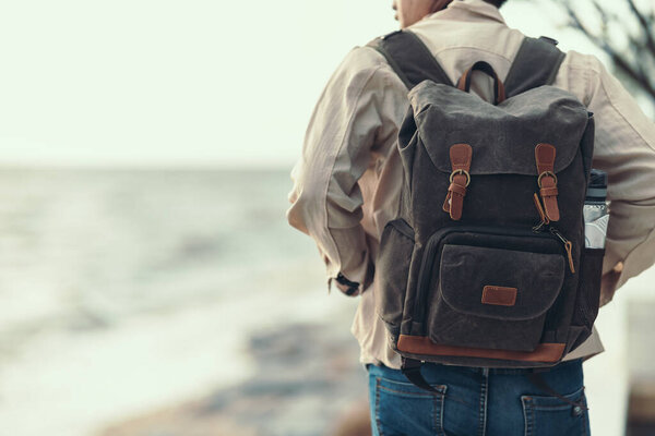 Tourists stand to watch sea sunset. backpacker, travel concept