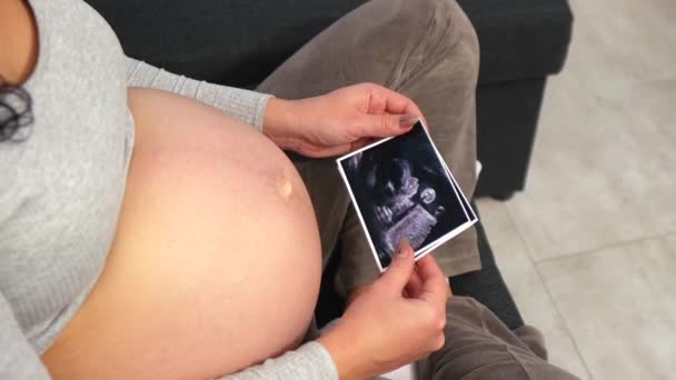 Pregnant Woman Comfortable Clothes Sits Floor Looks Ultrasound Photo Her — Stockvideo