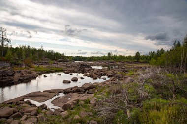 Stone River. Summer landscape of a river with rocks and forest in Belomorsk, Karelia, Russia.