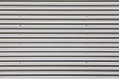 Wide shot of silver corrugated metal with bolts clipart