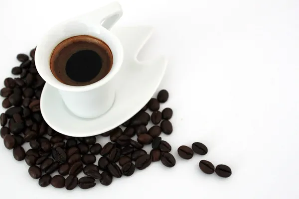 Cup of coffee and coffee beans on white — Stock Photo, Image