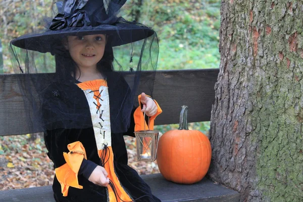 Witch child with latern and pumpkin — Stock Photo, Image