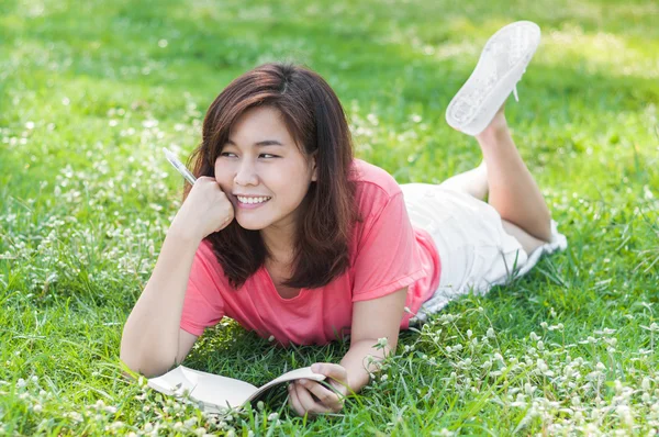 Happy Young Asian Woman Writing in Notebook and Smiling — Stock Photo, Image