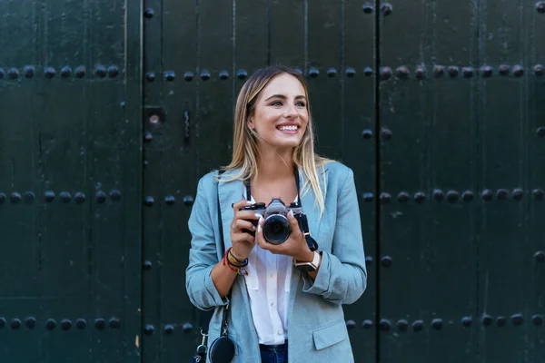 Content woman with vintage camera in street — Stock Photo, Image